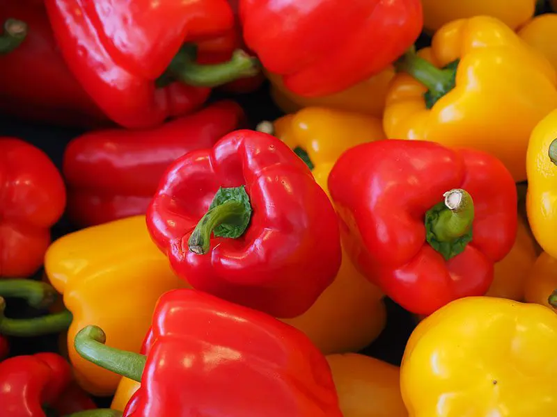 Close-up image of a group of red and yellow bell peppers.