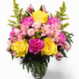 arrangement with bright, sunny yellow roses, delicate solidago, charming pink Peruvian lilies, sweet pink carnations, dainty pink mini carnations, and lush assorted greenery