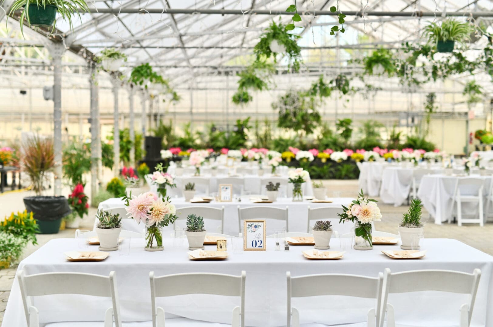 Greenhouse wedding reception table setting.