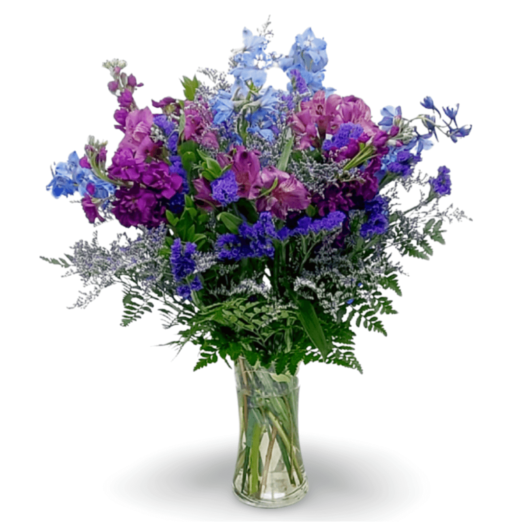 Purple and blue flower bouquet in vase.