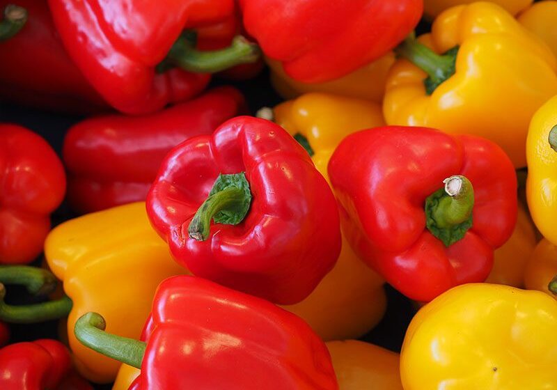 Close-up image of a group of red and yellow bell peppers.